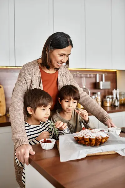 A delighted family prepares festive treats together, with children eagerly tasting their delicious creations. — Stock Photo