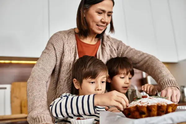 A joyful family enjoys baking festive treats in their modern kitchen, creating cherished holiday memories together. — Stock Photo