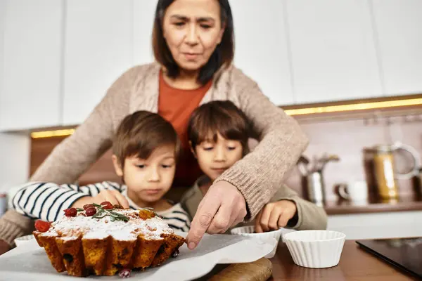 An Asian family enjoys baking delicious pastries together in their modern kitchen, celebrating the holidays. — Stock Photo