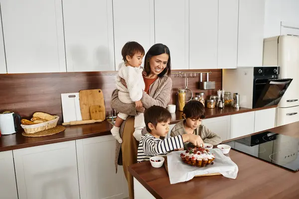 A cheerful family enjoys baking festive goodies together, creating sweet holiday memories in their kitchen. — Stock Photo