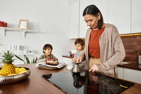 A happy family gathers in their modern kitchen, creating delicious treats together for Christmas. — Stock Photo
