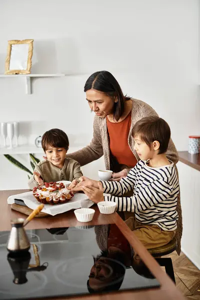 A cheerful family enjoys baking cake together in their contemporary kitchen as winter holidays approach. — Stock Photo