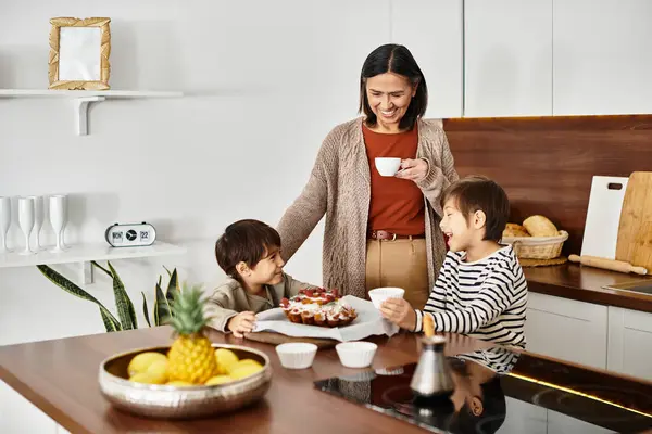 A cheerful family enjoys baking holiday treats in their stylish kitchen, creating memories with festive joy. — Stock Photo