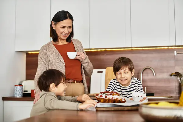 A cheerful family enjoys baking holiday treats in their modern kitchen, sharing laughter and love. — Stock Photo