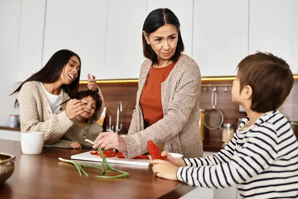 A cheerful Asian family enjoys cooking together in their contemporary kitchen while celebrating the holidays. — Stock Photo