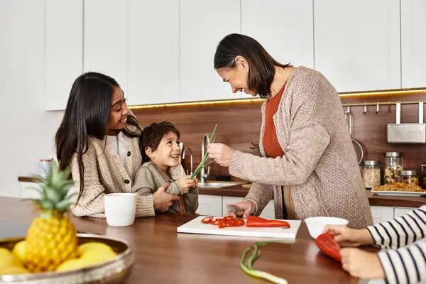 A joyful Asian family cooks together in a sleek kitchen, enjoying the festive spirit and creating holiday treats. — Stock Photo