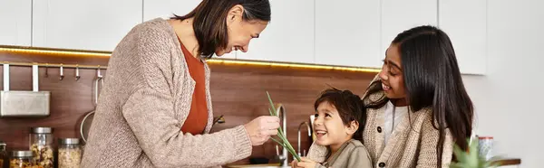 A cheerful family enjoys cooking in their contemporary kitchen, creating holiday treats together. — Stock Photo
