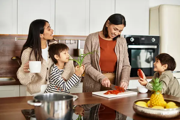 A joyful Asian family prepares festive treats together, creating cherished holiday memories in their kitchen. — Stock Photo