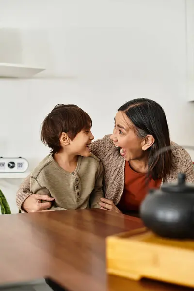A cheerful family, an asian grandmother and grandson, in modern kitchen before Christmas. — Stock Photo
