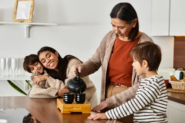 A happy family making tea together in a modern kitchen, sharing laughter and joy — Stock Photo