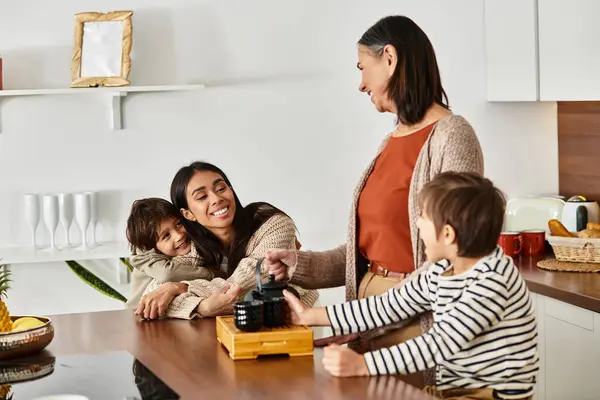 A joyful family making tea together, sharing laughter and love in the kitchen. — Stock Photo