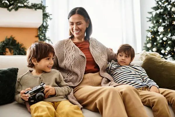 A joyful Asian family enjoys a cheerful Christmas gathering surrounded by festive decorations. — Stock Photo
