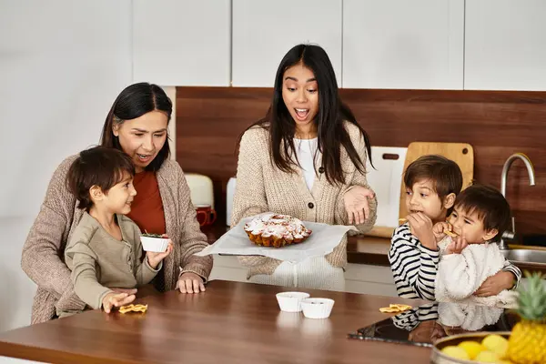 A cheerful family with children delights in baking festive treats in their cozy kitchen this winter. — Stock Photo