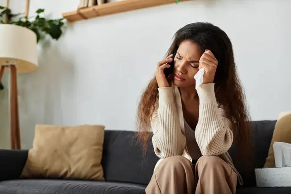 A woman expresses her emotions while communicating on the phone, feeling distressed at home. — Stock Photo