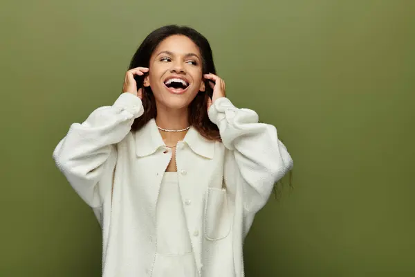The woman expresses delight, radiating happiness while surrounded by a calming green hue. — Stock Photo