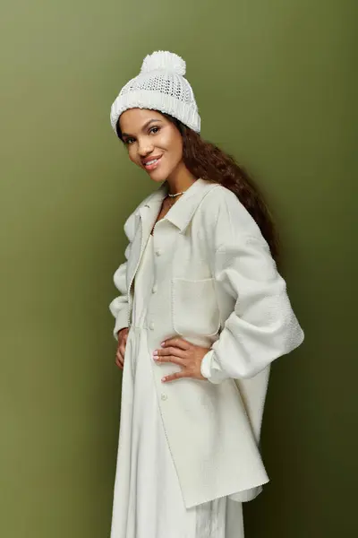 A stylish woman stands confidently, showcasing her cozy attire and playful expression in autumn. — Stock Photo