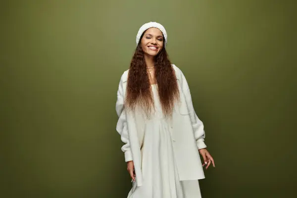 A beautiful woman dressed in soft white exudes happiness while posing brightly. — Stock Photo