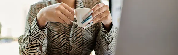 A beautiful bald woman enjoys her tea thoughtfully while seated in a warm office. — Stock Photo