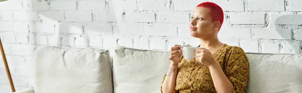 The bald woman enjoys a calming tea moment in a cozy living space filled with light. — Stock Photo