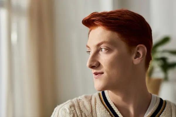 The young man with fiery red hair reflects warmly in a serene setting during Christmas celebrations. — Stock Photo