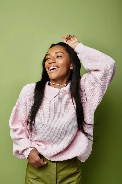 The young woman radiates joy in her cozy pink sweater, embracing autumn vibes. — Stock Photo