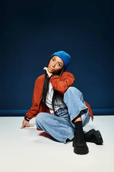 A young woman exudes confidence in her stylish autumn attire, showcasing a playful pose. — Stock Photo