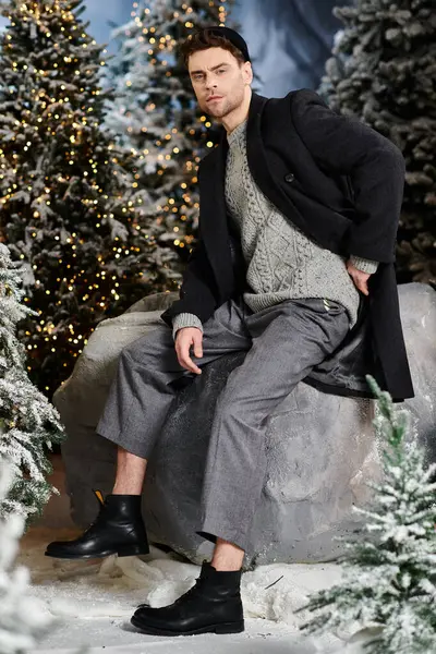 Bundled in winter attire, a handsome man enjoys the snowy atmosphere near picturesque pines during Christmas. — Stock Photo