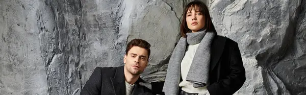 A couple in winter coats looking at camera outdoors — Stock Photo