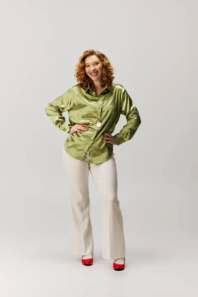 A young woman with curly hair and a bright smile posing with enthusiasm. — Stock Photo