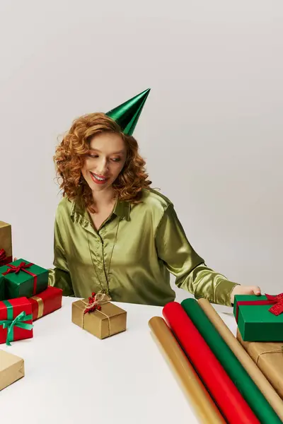 The young woman is happily posing cheerfully with vibrant wrapping paper while celebrating. — Stock Photo
