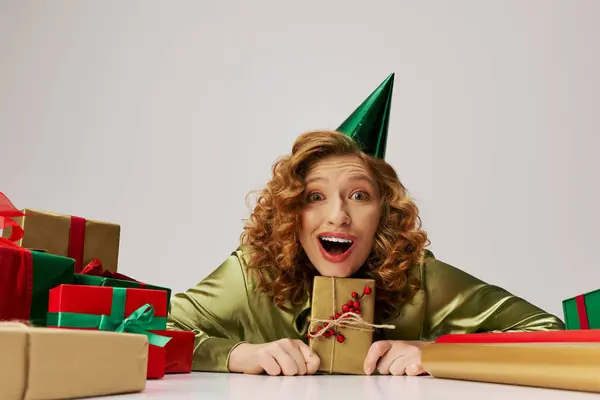 A cheerful young woman posing while wearing a playful party hat in a festive setting. — Stock Photo