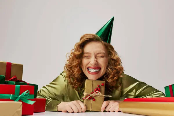 A cheerful young woman posing with delight during a festive celebration at home. — Stock Photo