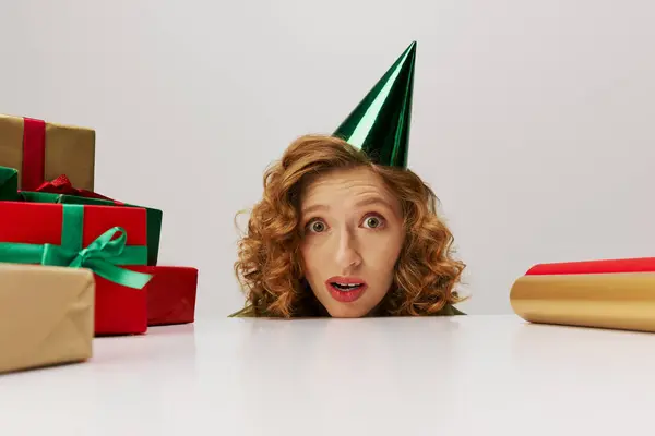 A young woman is enthusiastically preparing beautifully wrapped gifts with colorful decorations. — Stock Photo