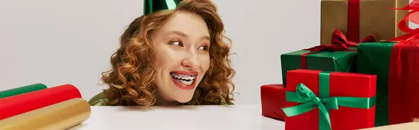 A joyful young woman with curly hair is excitedly celebrating. — Stock Photo