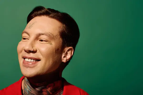 A tattooed young person beams joyfully in a creative setting. — Stock Photo
