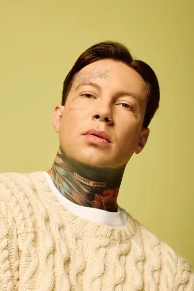 This young man showcases his intricate tattoos while exuding a sense of style and confidence. — Stock Photo