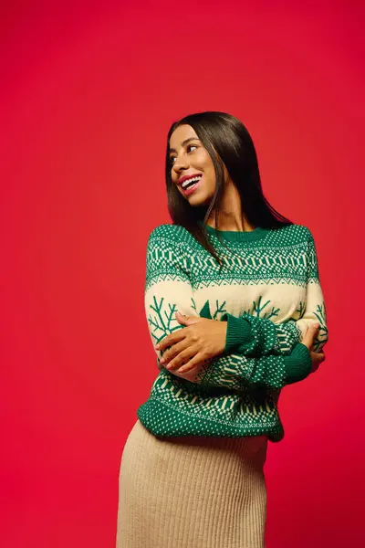 This young woman exudes happiness while wearing a cozy green sweater, creating a joyful atmosphere. — Stock Photo