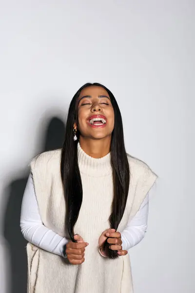 A young woman with long hair expresses pure delight while enjoying a moment of happiness. — Stock Photo
