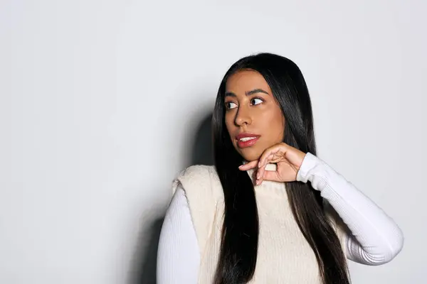 A young woman with long hair displays a thoughtful expression while turning her head gracefully. — Stock Photo