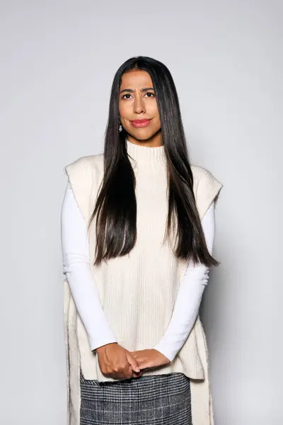 The young woman exudes charm in a soft, textured outfit, showcasing natural beauty and style. — Stock Photo
