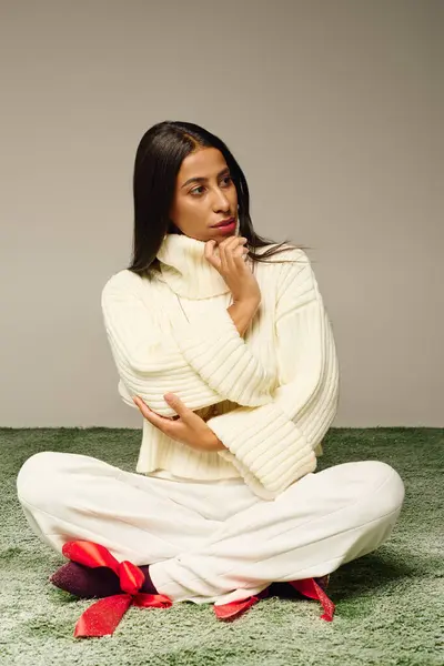 The young woman exudes elegance while sitting cross legged in a tranquil environment. — Stock Photo