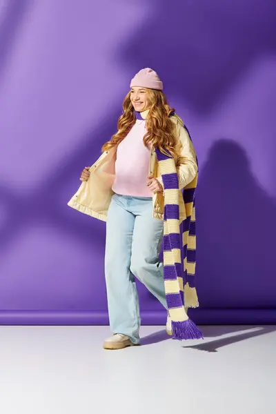 A plus size woman elegantly showcases her stylish winter ensemble with playful accessories. — Stock Photo