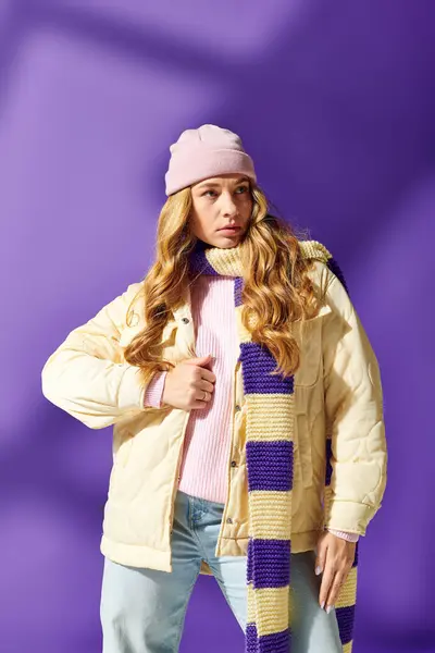 A fashionable young woman enjoys the warmth of her winter attire while showcasing a playful look. — Stock Photo
