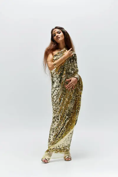 A radiant African American goddess exudes confidence in her shiny golden dress while striking a pose. — Stock Photo