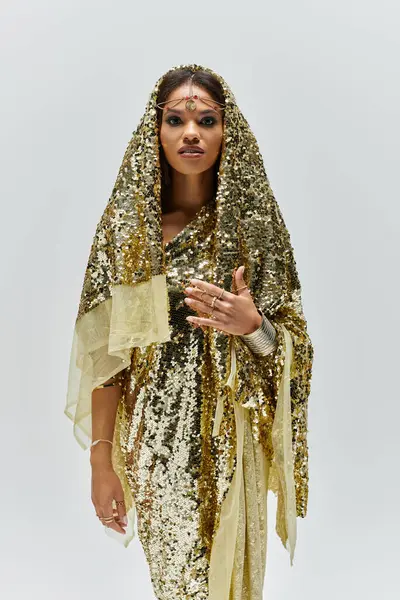 Gracefully posed in a golden dress, the African American goddess captivates with elegance and allure. — Stock Photo