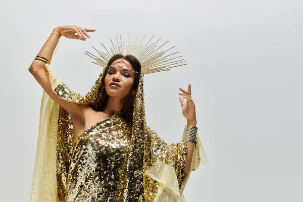 An elegant African American woman adorned in a dazzling golden dress moves with poise, showcasing her beauty. — Stock Photo
