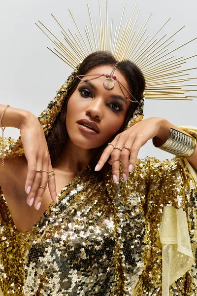 This striking African American goddess shines in a golden dress, exuding grace and confidence in a studio. — Stock Photo