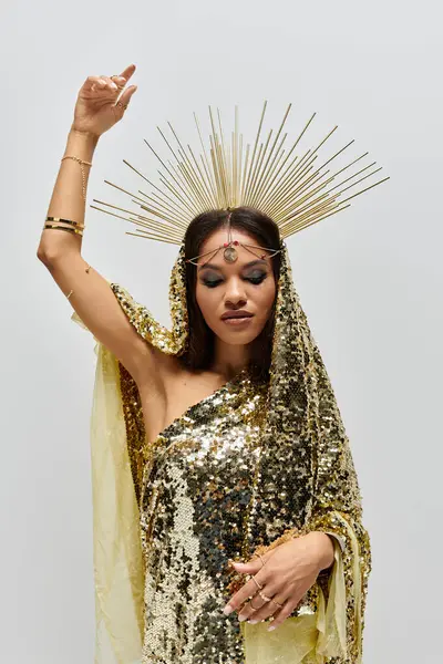 A stunning African American goddess in a golden gown embodies elegance and grace, radiating beauty in a studio. — Stock Photo