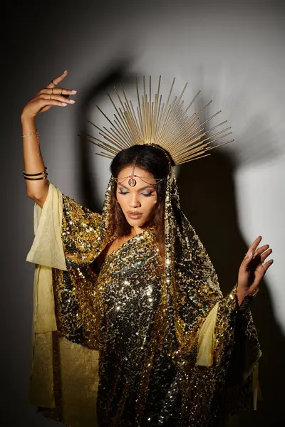 In a captivating studio, a stunning figure adorned in gold captivates with her graceful dance and elegance. — Stock Photo