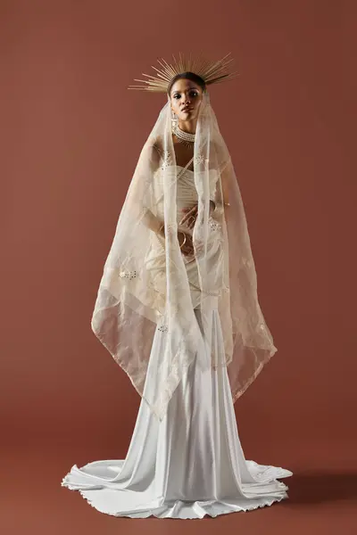 In a studio setting, a stunning African American woman showcases grace in a white dress with pearls. — Stock Photo